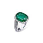White gold, diamond and emerald ring 18 kt white gold, consisting of diamonds totaling about 2.50 ct and a large central cushion-cut emerald of about 8.99 ct. Total weight 11.3 g, size 14